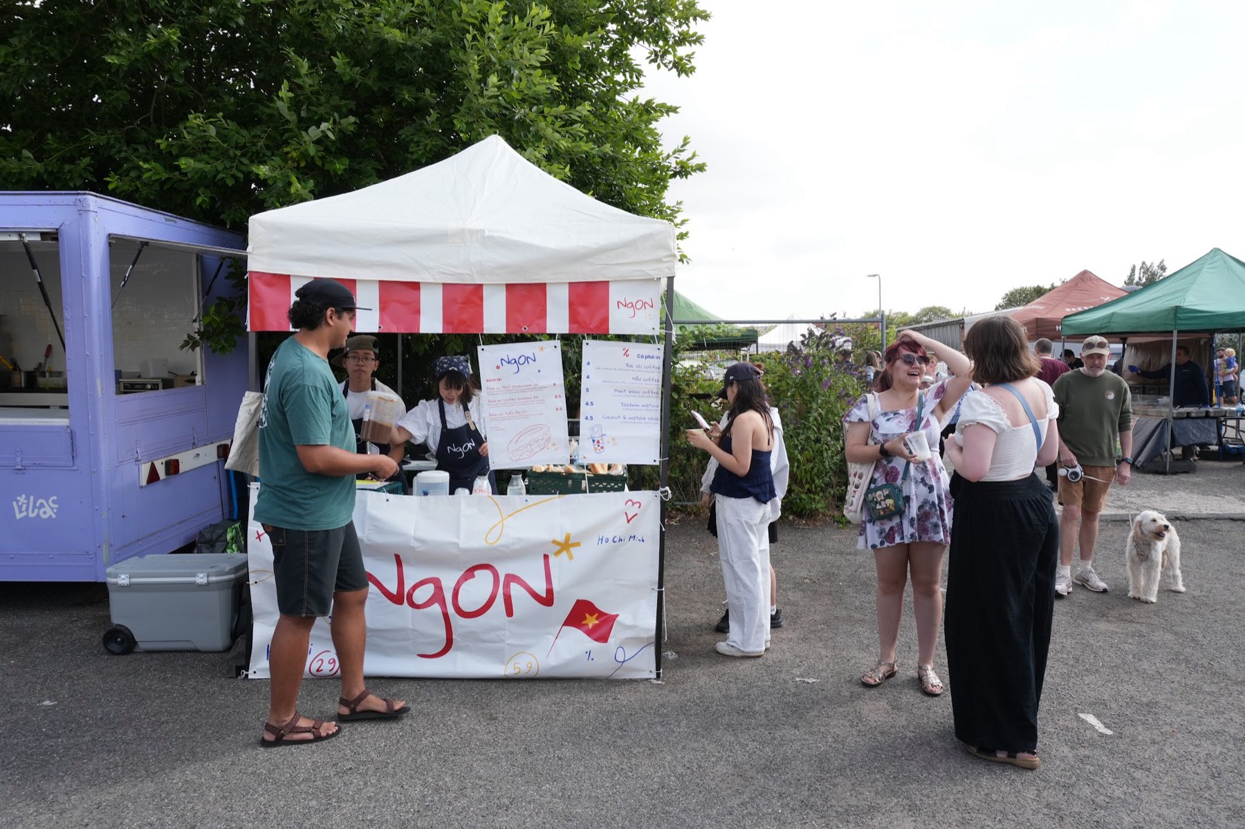 NgON's white gazebo with a red-and-white striped valance at The Garage, Chilwell, team members working behind a branded counter.